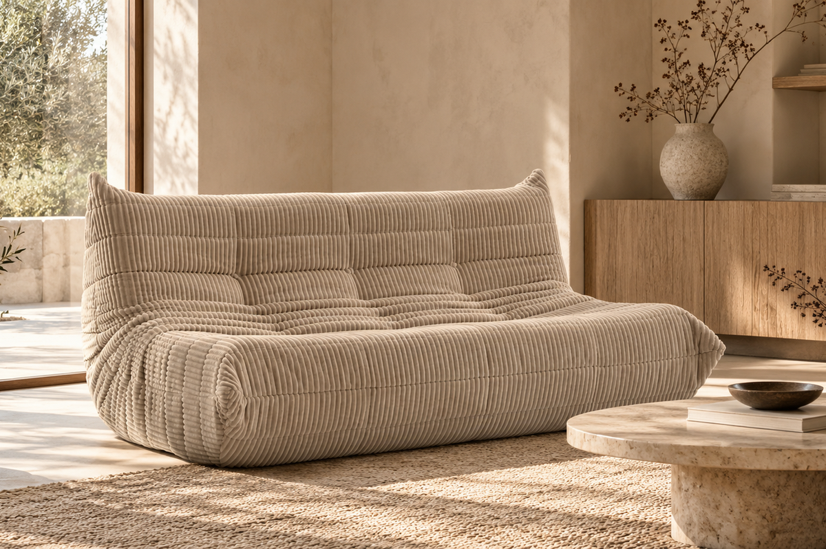 Beige corduroy sofa in a warm Japandi Wabi-Sabi living room with natural wood, textured décor, and soft daylight.