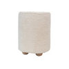 Front view of a cylindrical cream bouclé upholstered pouf featuring three rounded natural wood feet