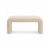 Front view of a minimalist waterfall bench fully upholstered in cream bouclé fabric with a seamless curved silhouette