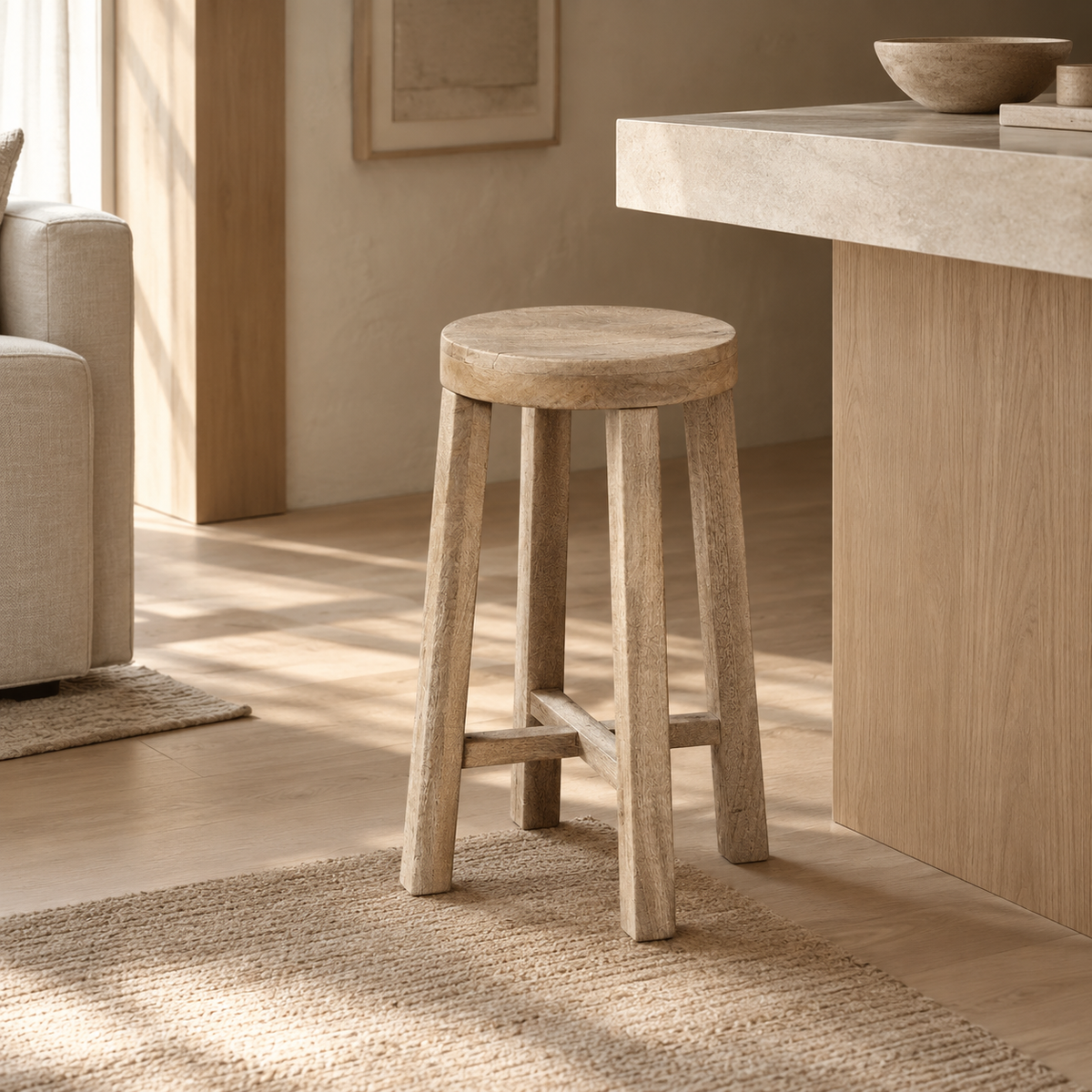 A rustic light oak wood stool with a round seat and four legs connected by a crossbar, shown on a white background.