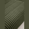Detailed view of the olive green ribbed fabric texture highlighting the vertical tufting.