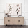 Lifestyle shot featuring the sideboard styled in a bright dining space with large floral triptych wall art