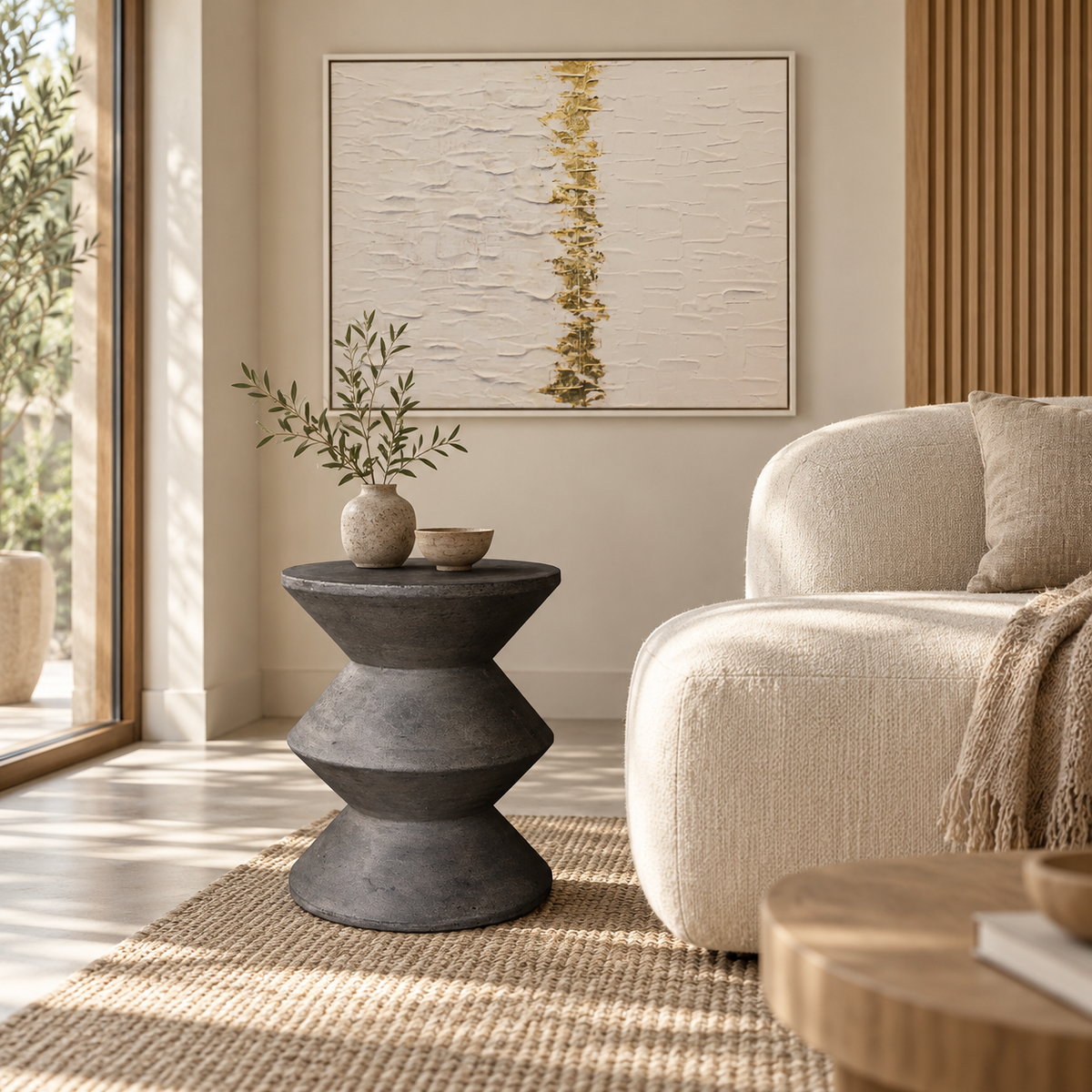 Front view of the sculptural side table in dark grey concrete featuring three stacked inverted cone sections for a bold geometric silhouette