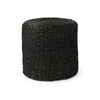 Front three-quarter view of the Dina round pouf featuring a dense handcrafted weave of black cornhusk and water hyacinth