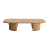 Front view of the Ekera coffee table featuring a soft rounded rectangular top and thick natural wood pedestal legs