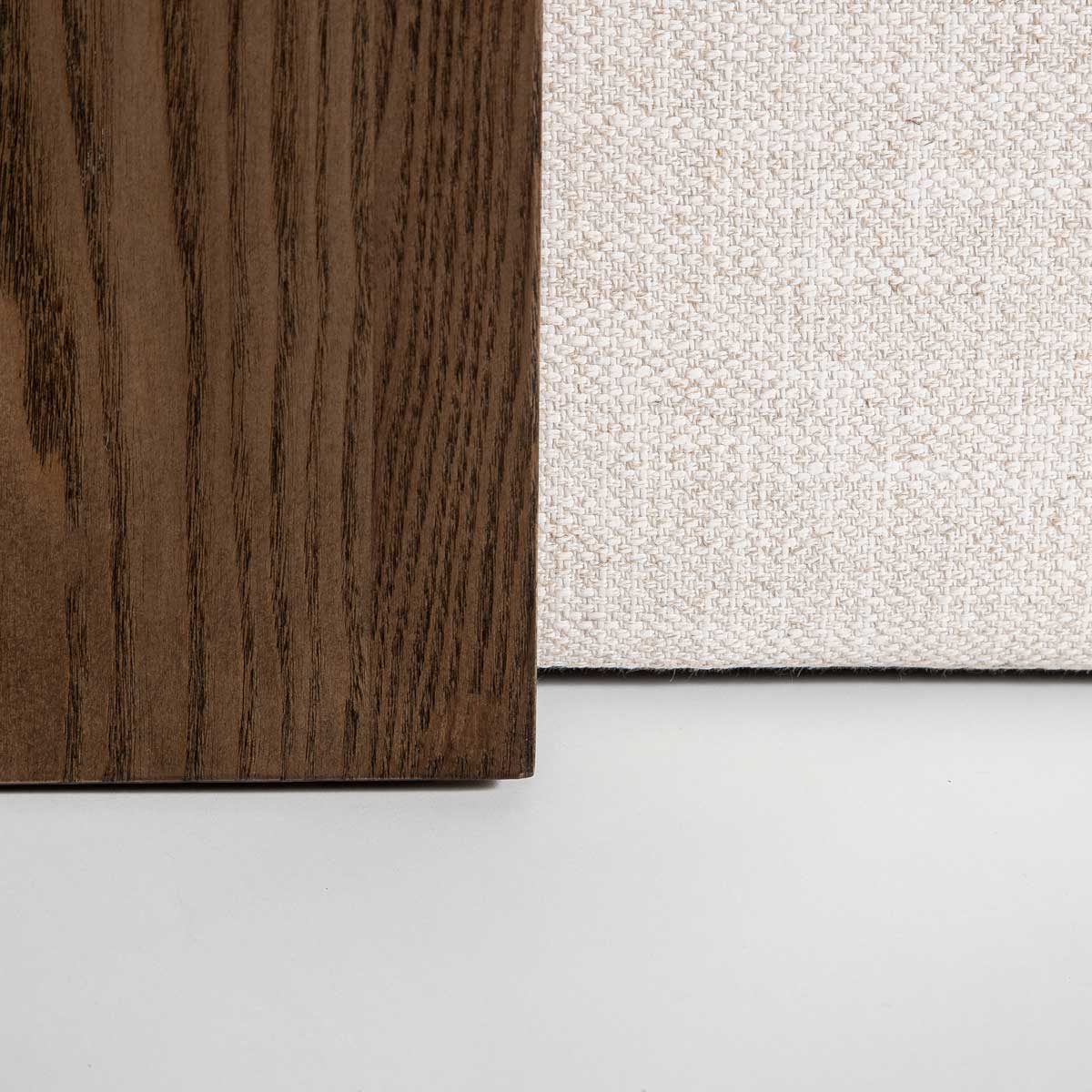 Front view of the Forest coffee ottoman featuring a cream upholstered rectangular bench with a nested blonde oak waterfall table