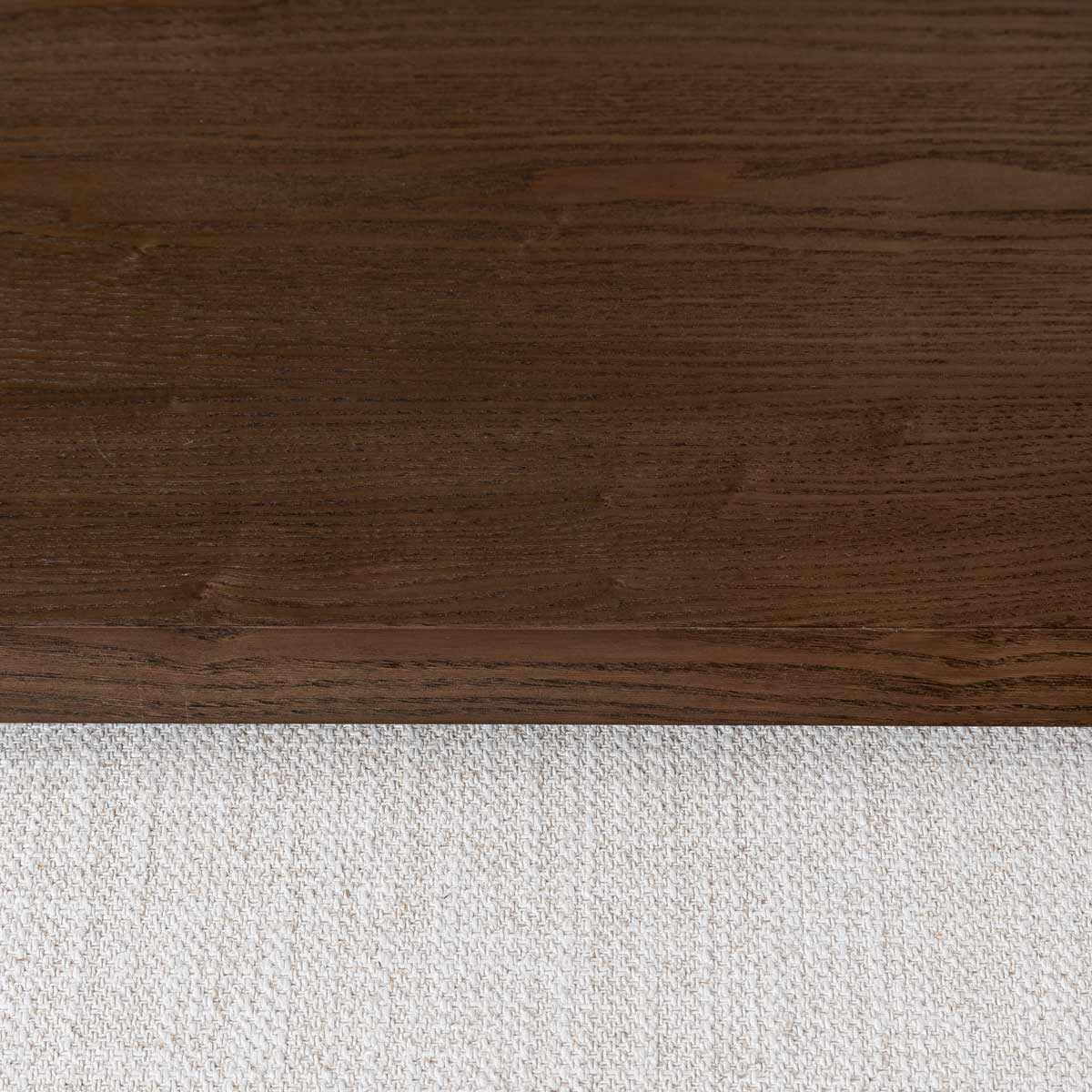 Front view of the Forest coffee ottoman featuring a cream upholstered rectangular bench with a nested blonde oak waterfall table