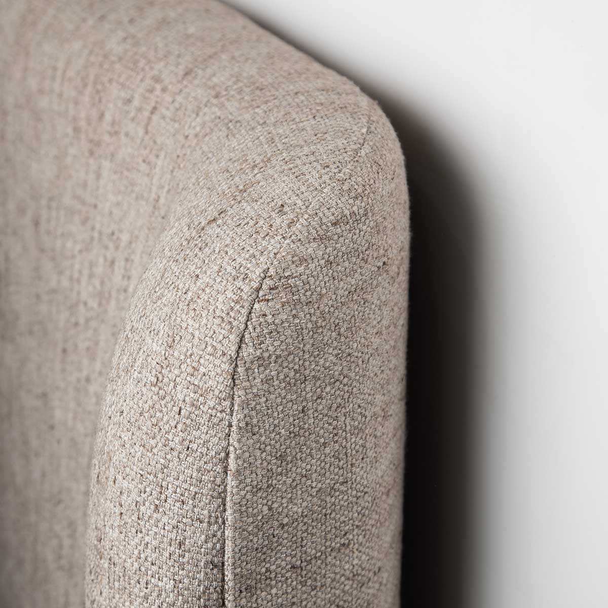 Front view of the Faye platform bed featuring a curved wingback headboard and textured taupe fabric upholstery