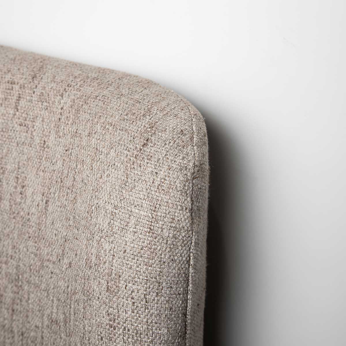Front view of the Faye platform bed featuring a curved wingback headboard and textured taupe fabric upholstery