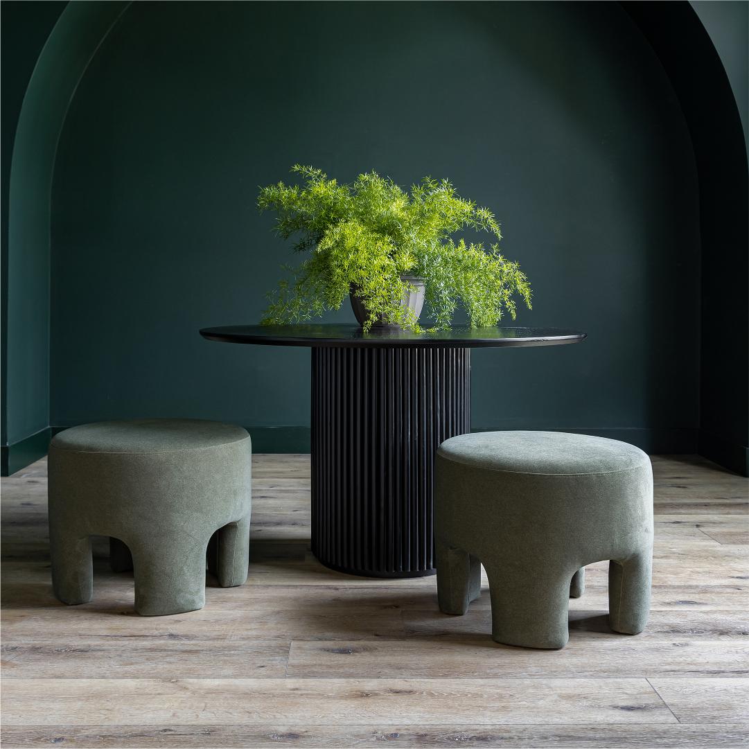 Front three-quarter view of the Ginger mushroom-shaped ottoman featuring rich chestnut brown velvet upholstery