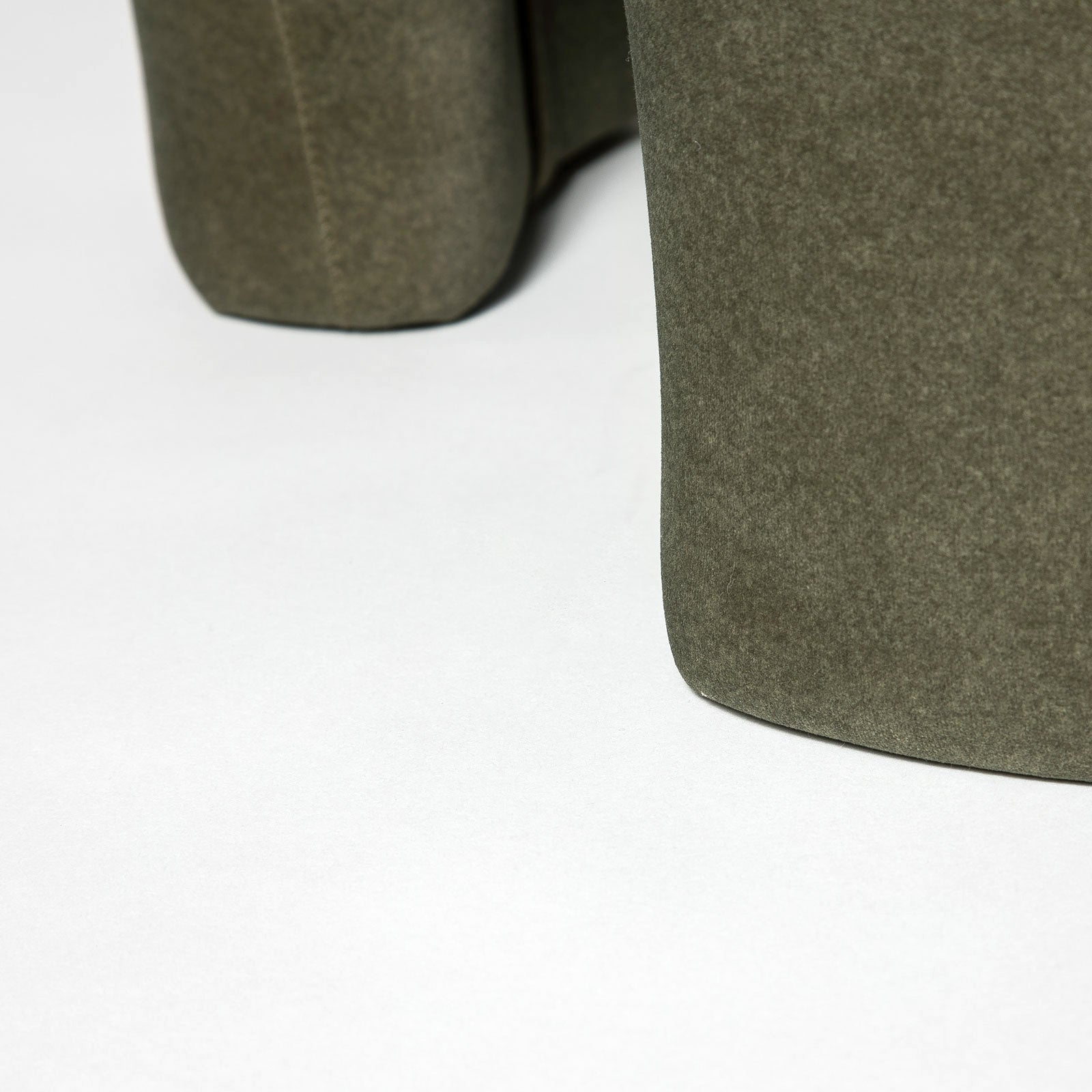 Front three-quarter view of the Ginger mushroom-shaped ottoman featuring rich chestnut brown velvet upholstery