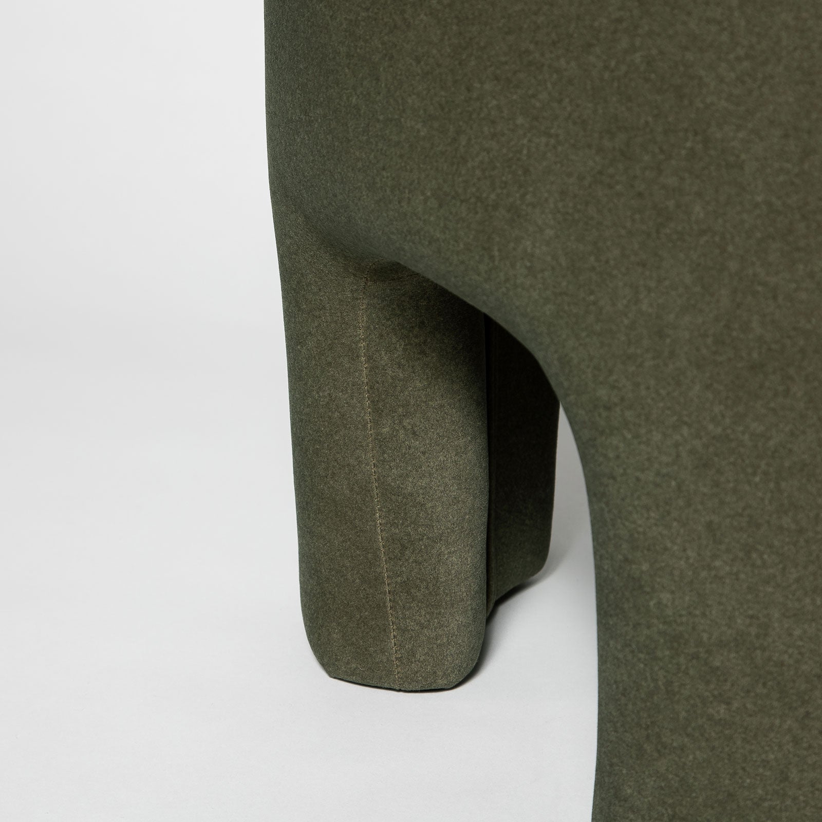 Front three-quarter view of the Ginger mushroom-shaped ottoman featuring rich chestnut brown velvet upholstery