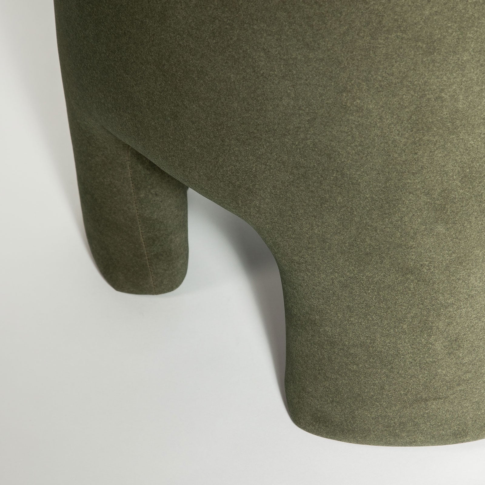 Front three-quarter view of the Ginger mushroom-shaped ottoman featuring rich chestnut brown velvet upholstery