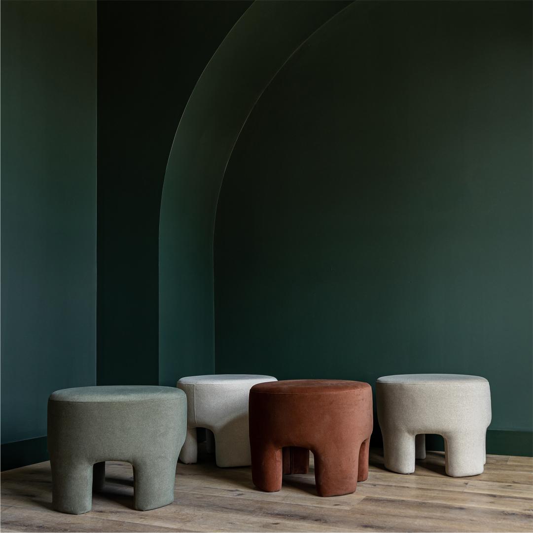 Front three-quarter view of the Ginger mushroom-shaped ottoman featuring rich chestnut brown velvet upholstery