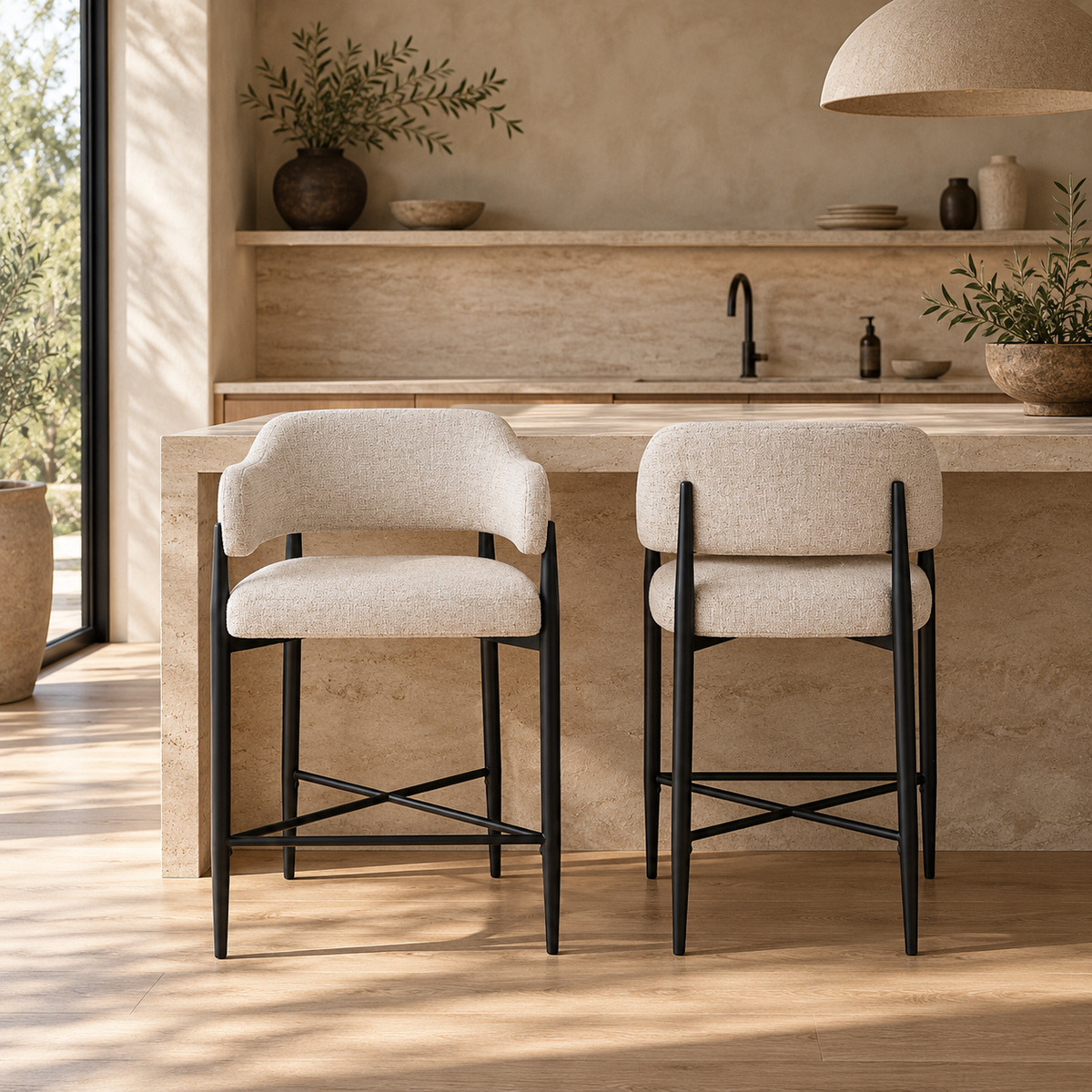 A modern counter-height bar stool with a light beige textured fabric upholstered seat and curved backrest, supported by a slim black metal frame with an X-shaped base.