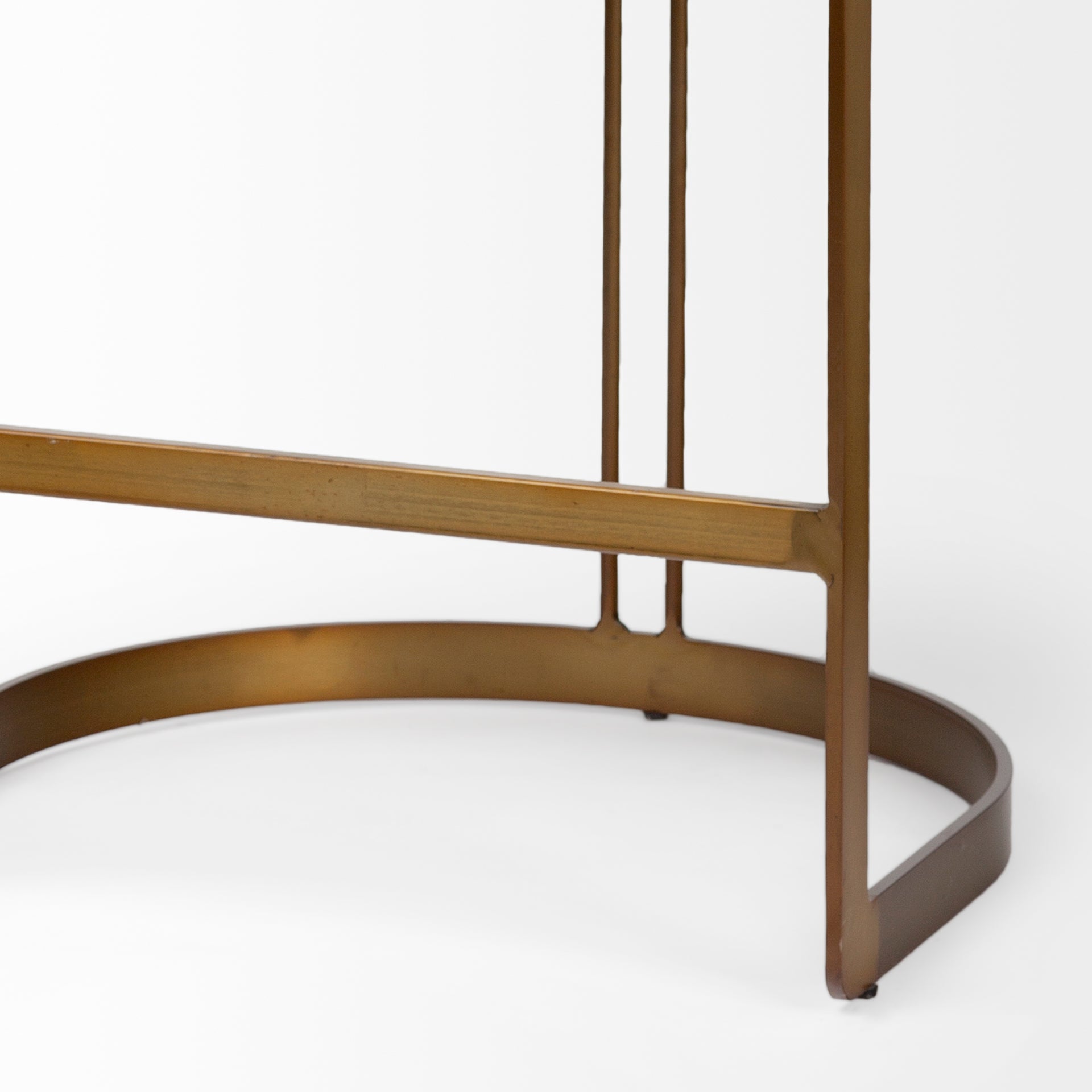 A modern bar stool featuring a curved brown leather seat cushion and backrest, supported by a slim gold-finished metal frame with a curved base, shown against a plain white background.