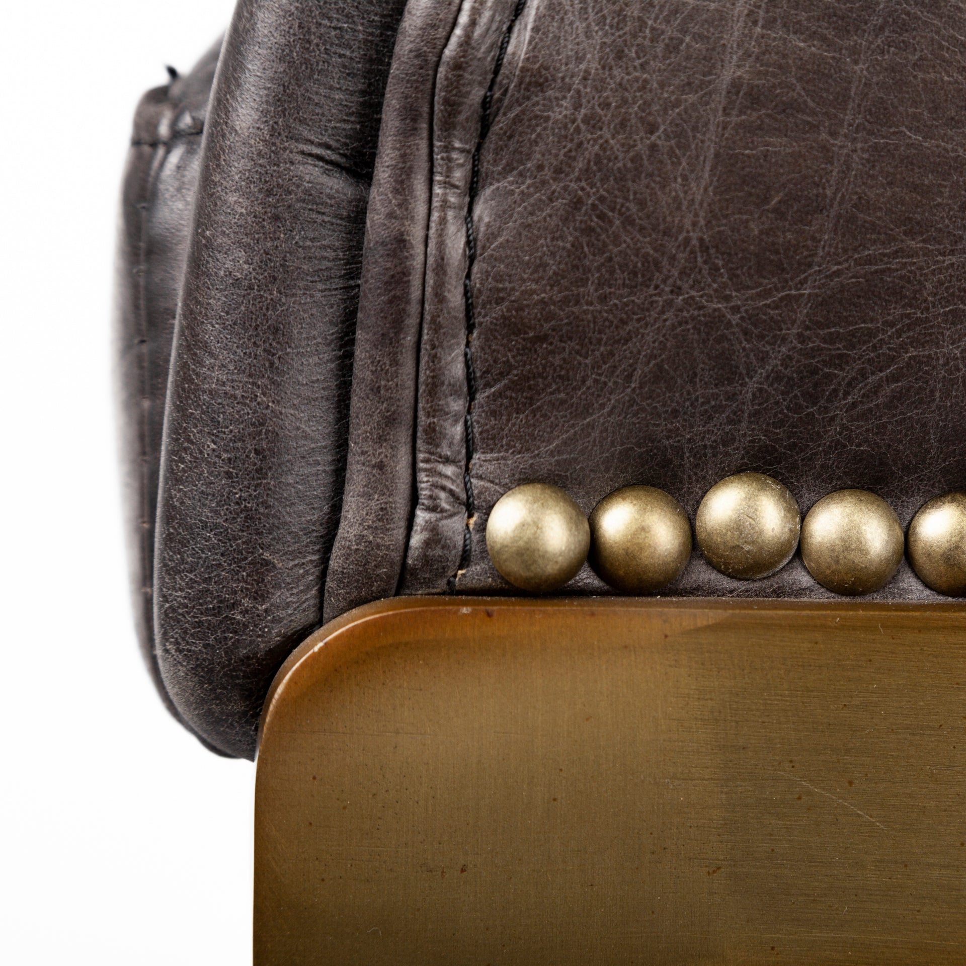 A modern bar stool featuring a curved brown leather seat cushion and backrest, supported by a slim gold-finished metal frame with a curved base, shown against a plain white background.