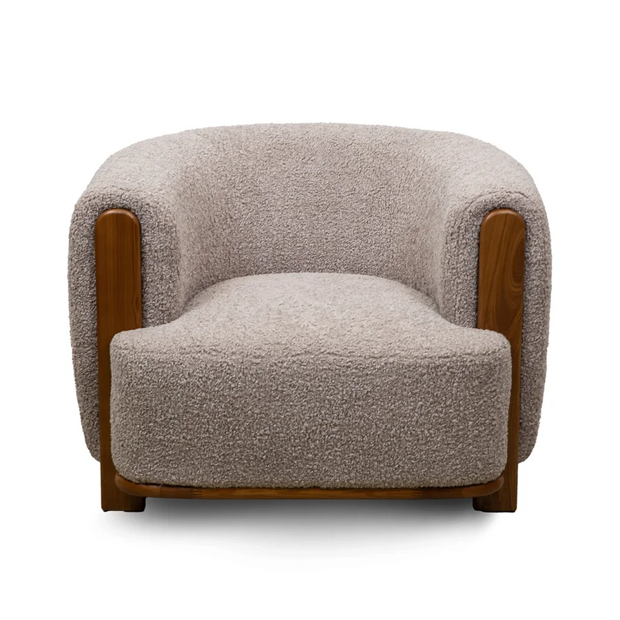 Front view of the Keji Armchair in pebble grey bouclé featuring a rounded silhouette and integrated natural wood frame
