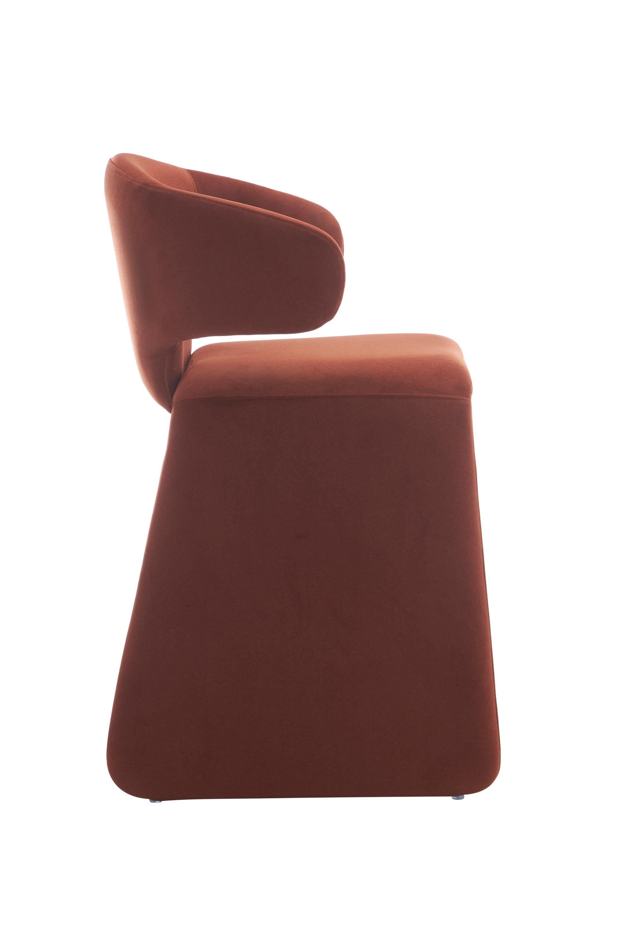rounded silhouette, fully upholstered seat, and supportive curved back. The sturdy metal frame and plywood reinforcement ensure long-lasting durability, while the soft polyester fabric adds a beautifully textured finish.