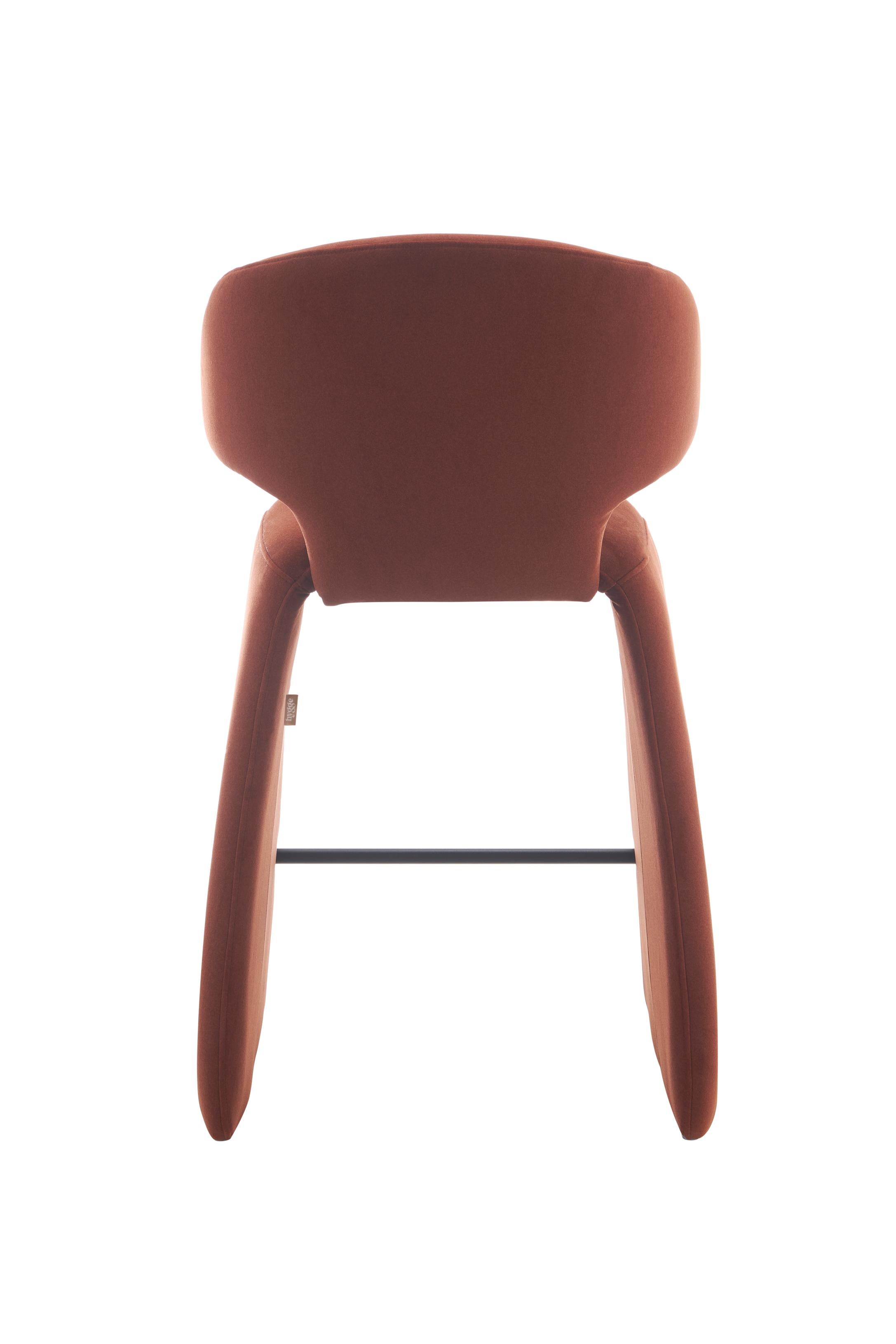 rounded silhouette, fully upholstered seat, and supportive curved back. The sturdy metal frame and plywood reinforcement ensure long-lasting durability, while the soft polyester fabric adds a beautifully textured finish.