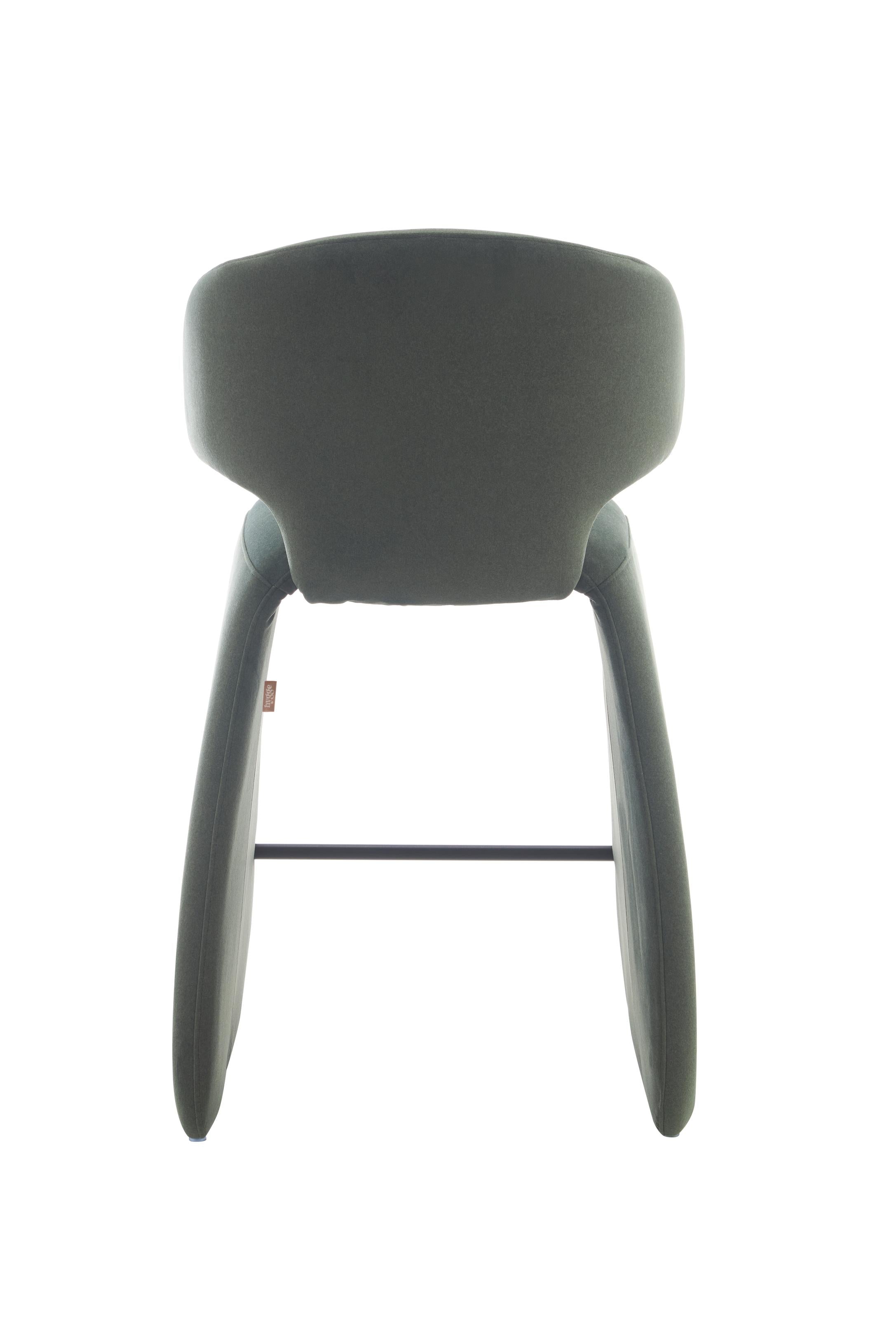rounded silhouette, fully upholstered seat, and supportive curved back. The sturdy metal frame and plywood reinforcement ensure long-lasting durability, while the soft polyester fabric adds a beautifully textured finish.