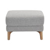 Front view of the Molly ottoman in grey bouclé featuring a tiered double-cushion design and flared natural wood legs