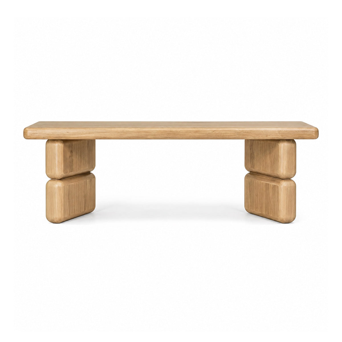 Front view of the Nelly dining bench in a lioness finish acacia wood featuring a thick rectangular top and block pedestal legs