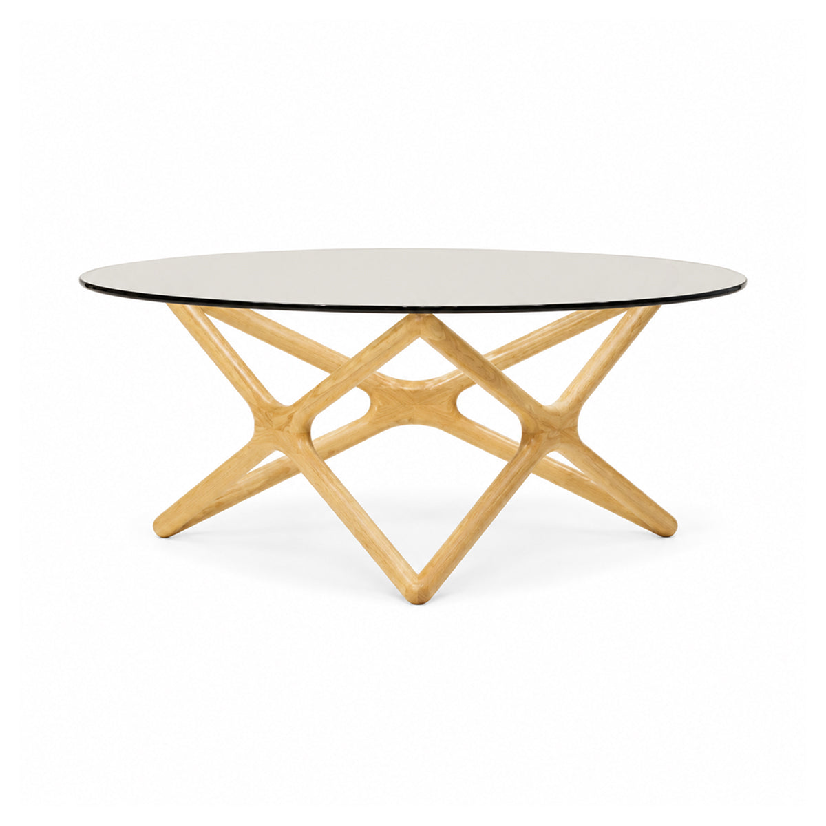 Front view of the Quasar coffee table featuring a circular glass top and a sculptural natural ash wood geometric base