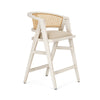 blonde Indian mango wood frame, triangular leg design, a curved cane back, and a padded natural linen seat.