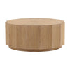 Front view of the Tamsin coffee table featuring a faceted drum silhouette in a natural oak finish