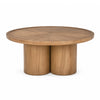 Front view of the Tavi round coffee table in a medium brown oak finish featuring a chunky double-cylinder pedestal base