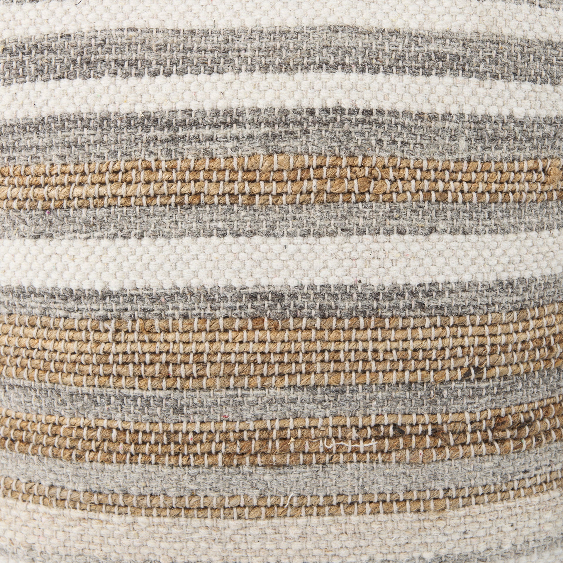 Elevated angled view showcasing the uniform striped pattern across the top and sides of the woven ottoman
