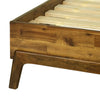 Detailed view of the bed frame corner highlighting the natural wood texture and the durable angled leg construction