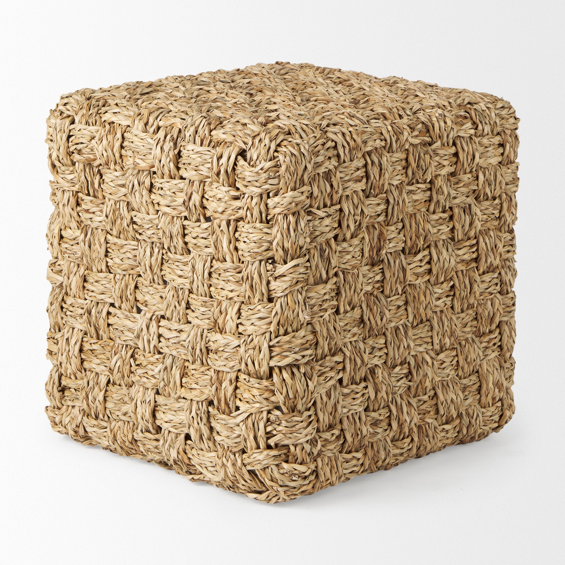 High-angled perspective showcasing the uniform square silhouette and handcrafted texture of the seagrass pouf