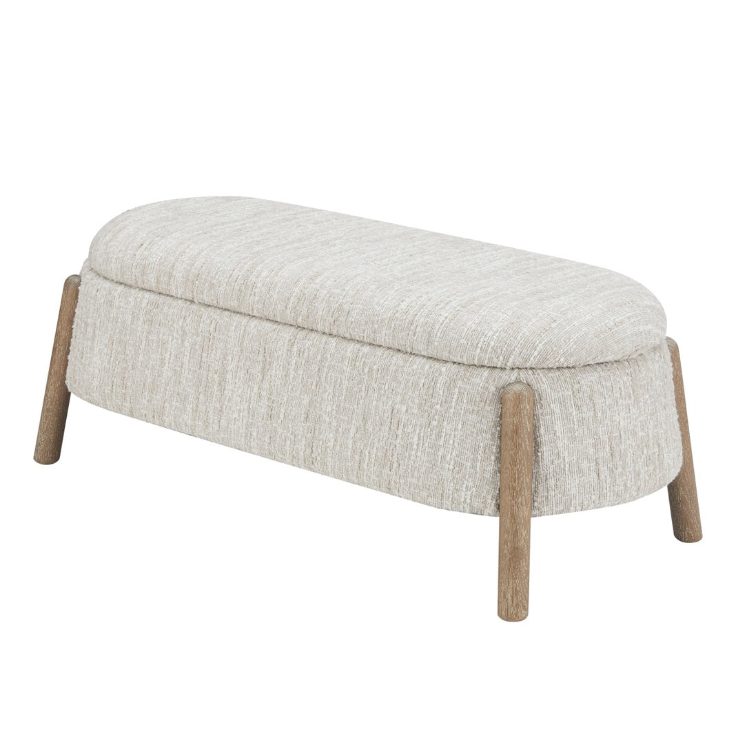 Front view of the Aero storage bench featuring cream textured upholstery and four tapered natural wood legs in a minimalist pill-shaped design