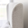 Side profile detail highlighting the elegant slim silhouette of the curved wingback headboard