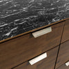 Perspective lifestyle shot highlighting the dresser's presence in a luxury master suite with designer lighting
