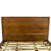 Close-up shot focusing on the smooth finished edges and natural wood grain of the walnut headboard