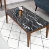 High-angle lifestyle shot of the marble tabletop styled with decorative accessories in a modern interior