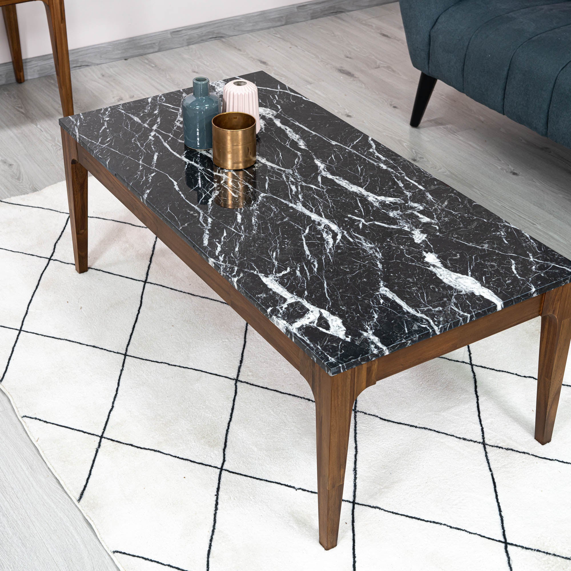 Front view of the Allure coffee table featuring a rectangular black marble top with white veining inset in a rich walnut wood frame
