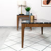 Perspective view of the Allure table paired with a matching walnut sideboard and contemporary lighting