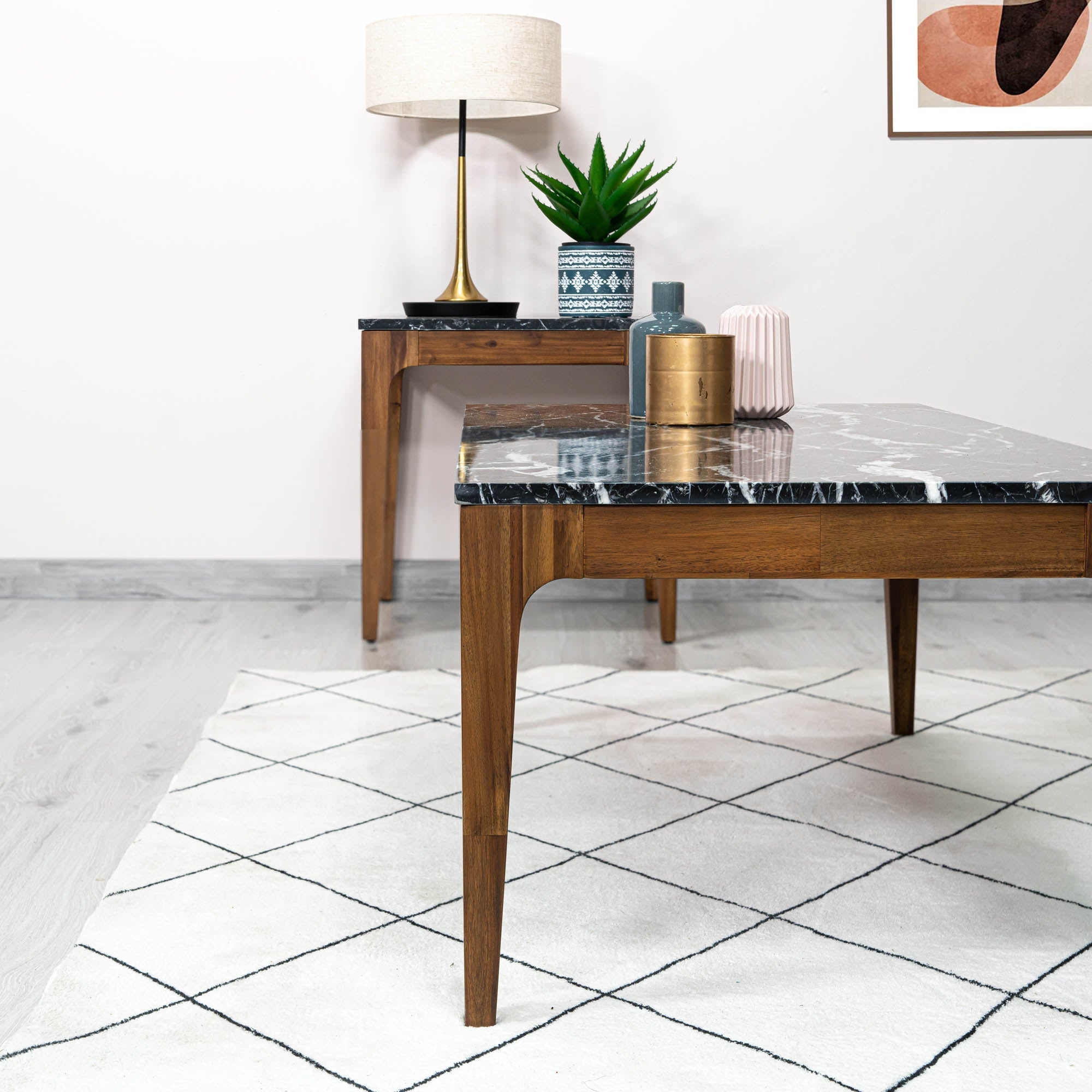 Front view of the Allure coffee table featuring a rectangular black marble top with white veining inset in a rich walnut wood frame