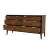 Studio lifestyle shot featuring the dresser styled in a bright, modern bedroom with neutral decor and natural lighting