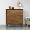 Studio lifestyle shot featuring the 4-drawer chest styled in a bright modern bedroom with a neutral ottoman and decorative accents