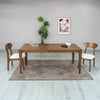 Studio lifestyle shot featuring the Allure table styled with two mid-century modern chairs in a bright room