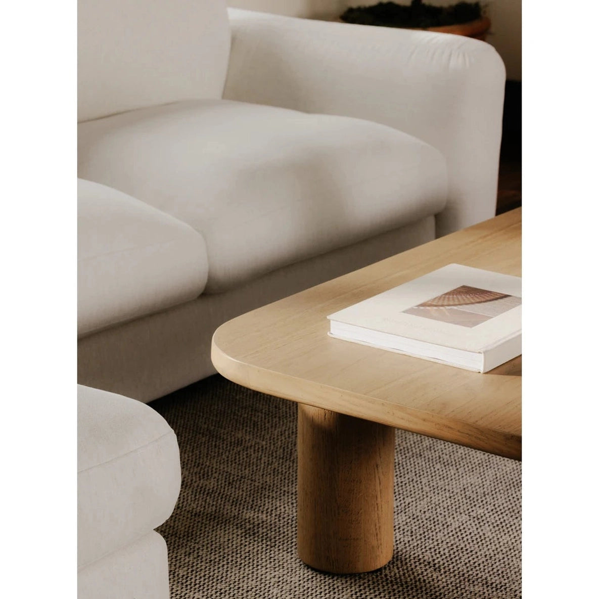 Close-up shot highlighting the soft rounded corners and seamless wood grain construction of the Anders coffee table