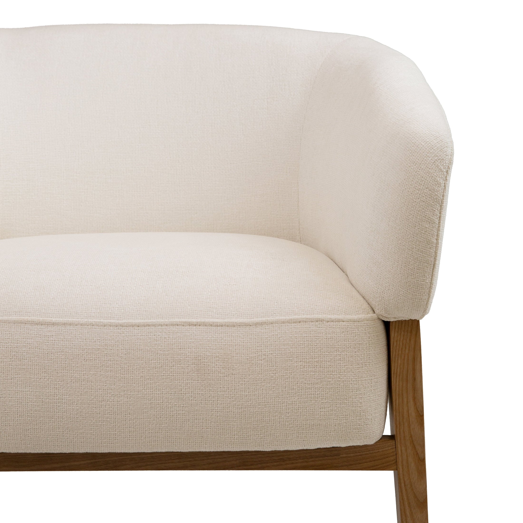 Front view of the Annika Accent Chair in Joyce Ivory textured fabric with a tapered oak wood base.