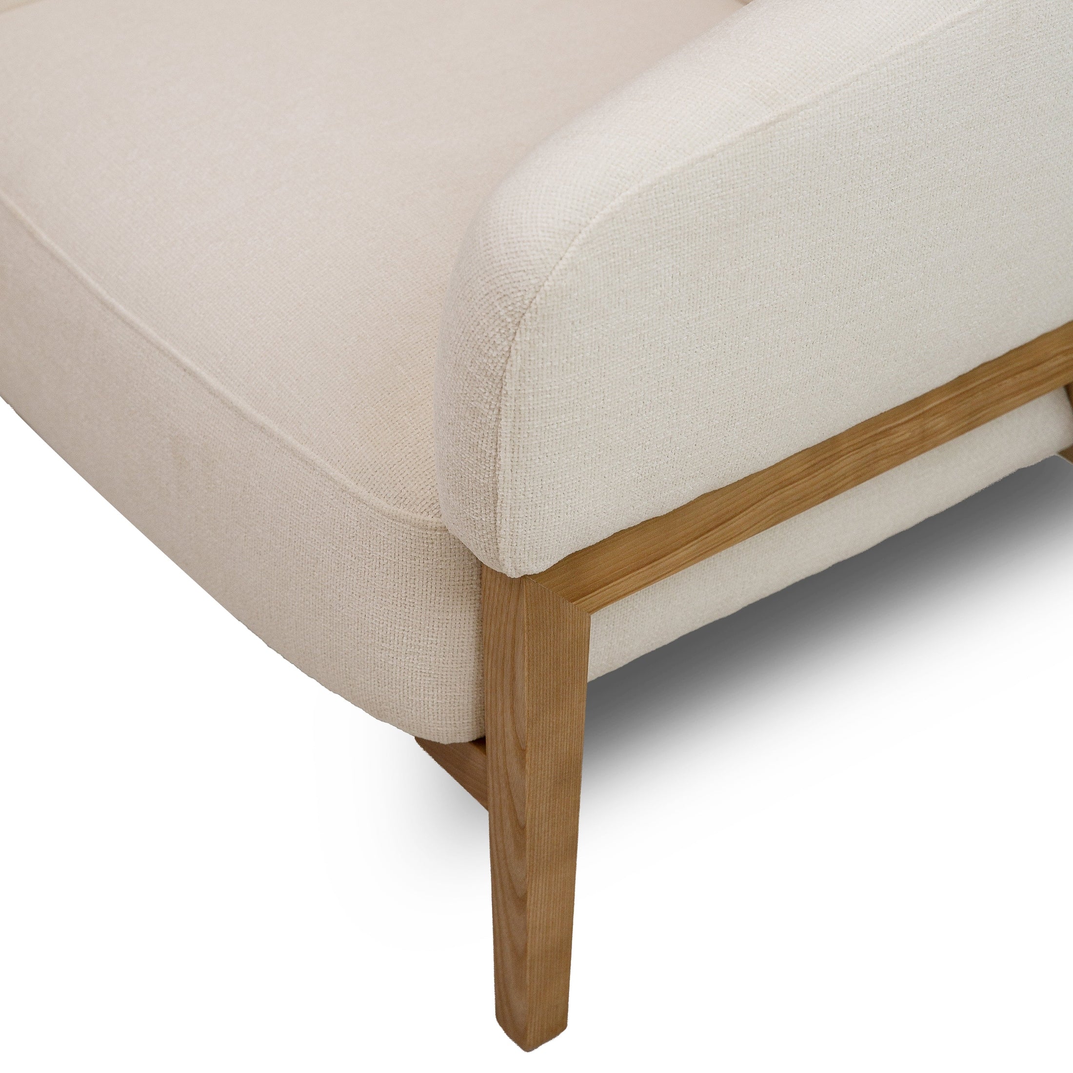 Front view of the Annika Accent Chair in Joyce Ivory textured fabric with a tapered oak wood base.