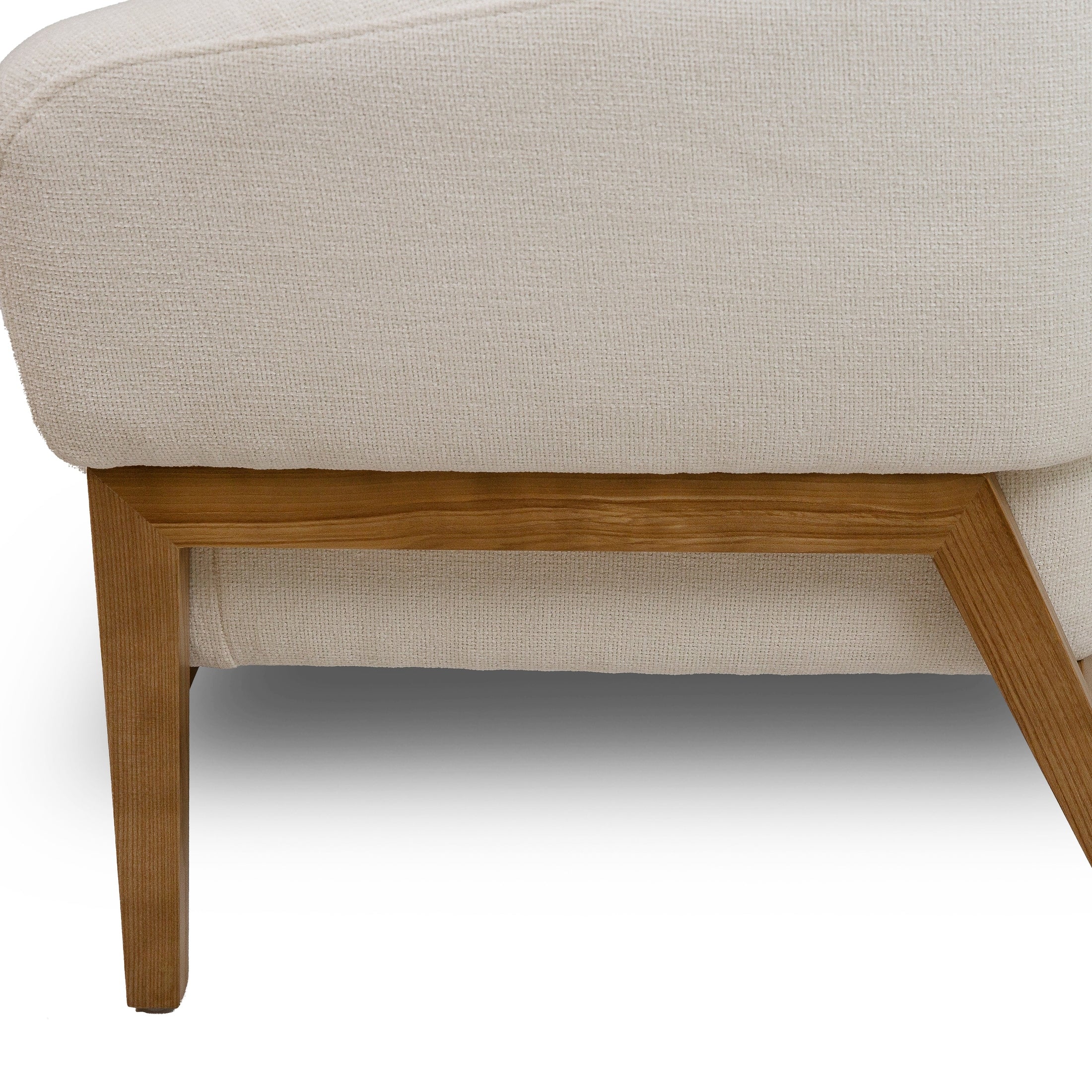 Front view of the Annika Accent Chair in Joyce Ivory textured fabric with a tapered oak wood base.