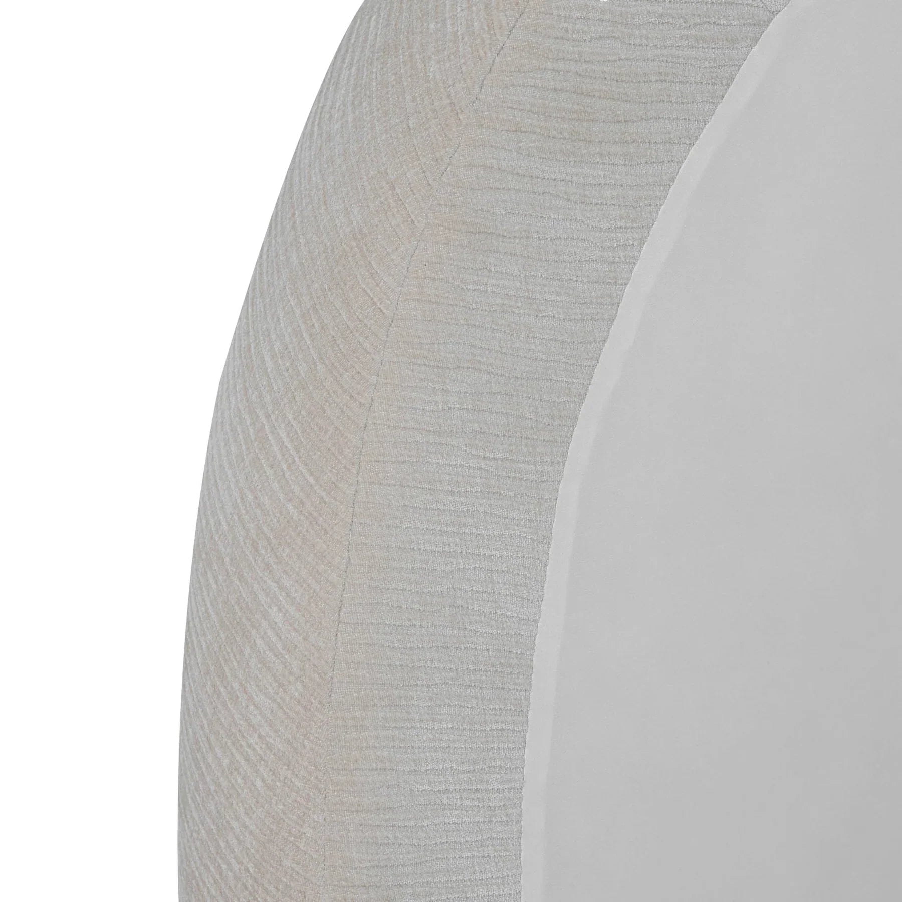 Perspective detail shot focusing on the smooth radius of the arched headboard and the intricate bouclé weave